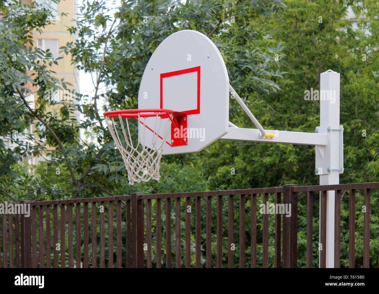 Basketball basket on children's playground in the yard of house Stock Photo  - Alamy