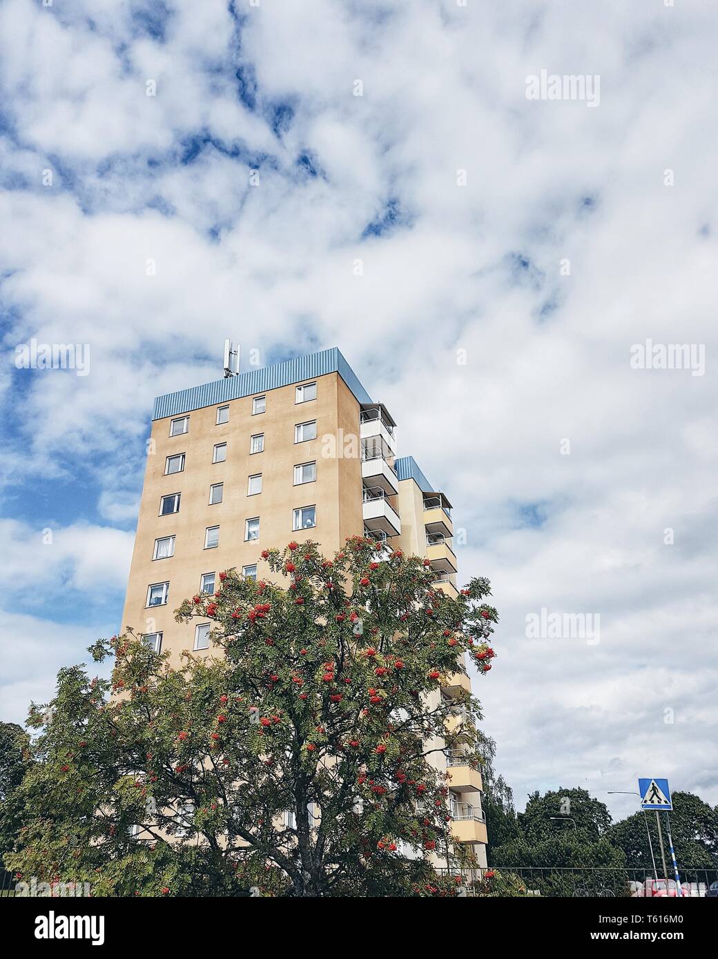 High building with apartments against a cloudy sky Stock Photo - Alamy