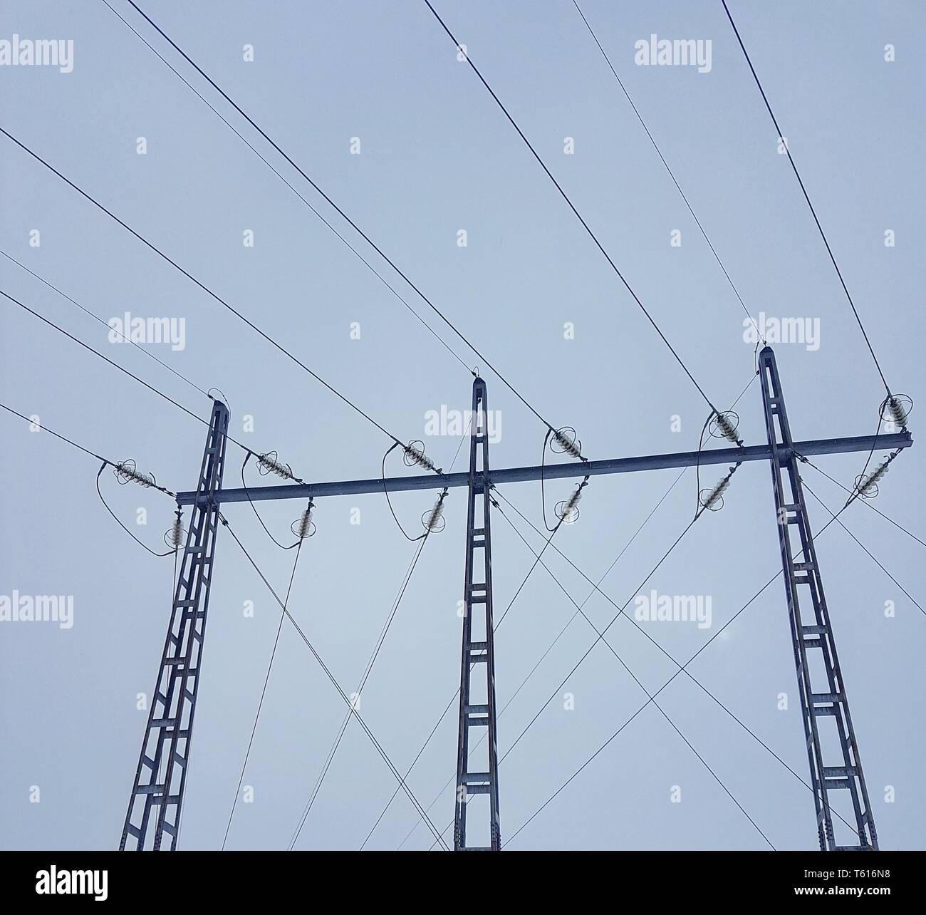 Power lines against a cloudy sky Stock Photo - Alamy