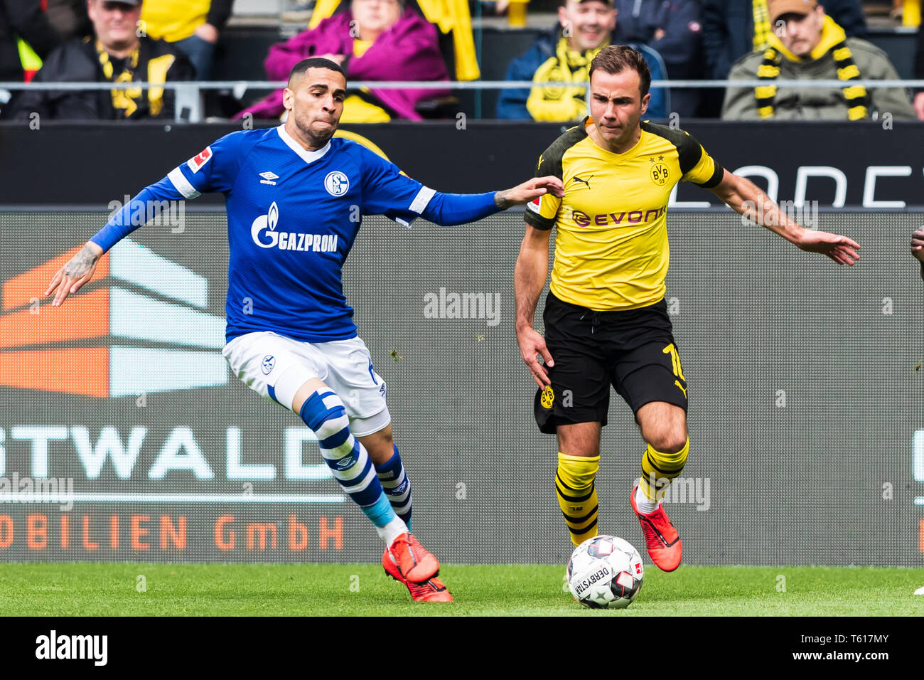 27 april 2019 Dortmund, Germany Soccer German Bundesliga Borussia Dortmund v Schalke 04   L-R Omar Mascarell (Schalke 04) and Mario Gotze of Borussia Dortmund Stock Photo