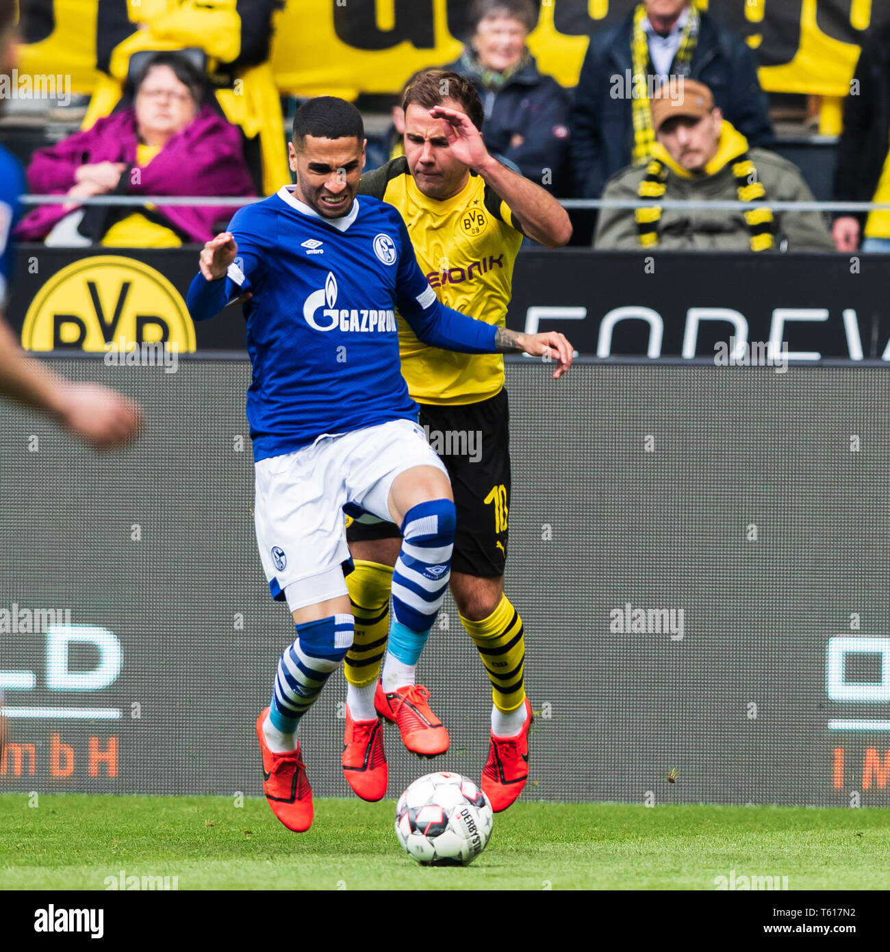 27 april 2019 Dortmund, Germany Soccer German Bundesliga Borussia Dortmund v Schalke 04   L-R Omar Mascarell (Schalke 04) and Mario Gotze of Borussia Dortmund Stock Photo