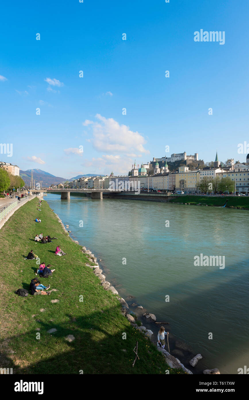 Salzburg summer, view of people relaxing beside the Salzach River in summer with the baroque Old Town (Altstadt) visible in the distance, Austria. Stock Photo
