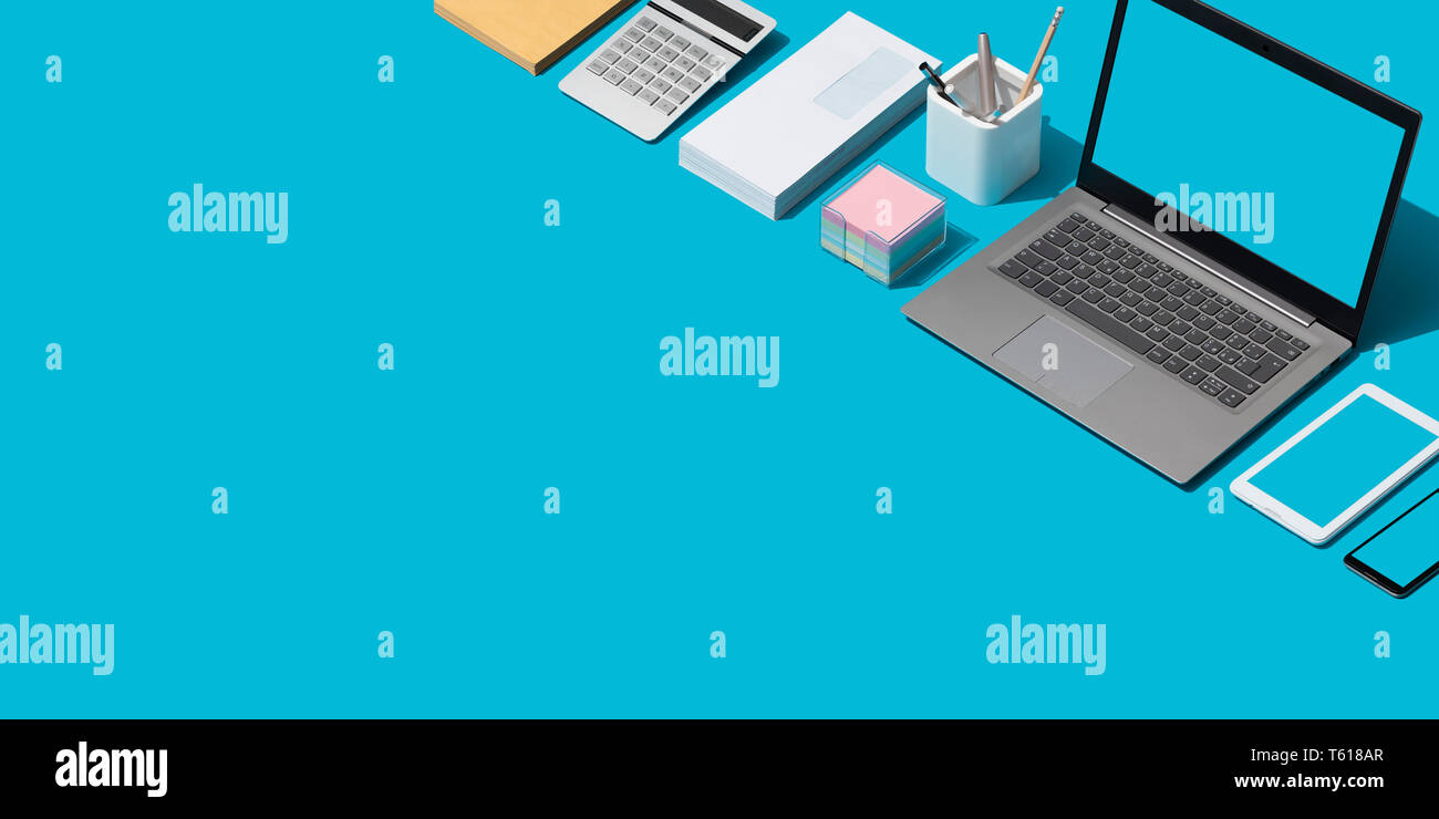 Contemporary corporate business desktop with laptop and isometric