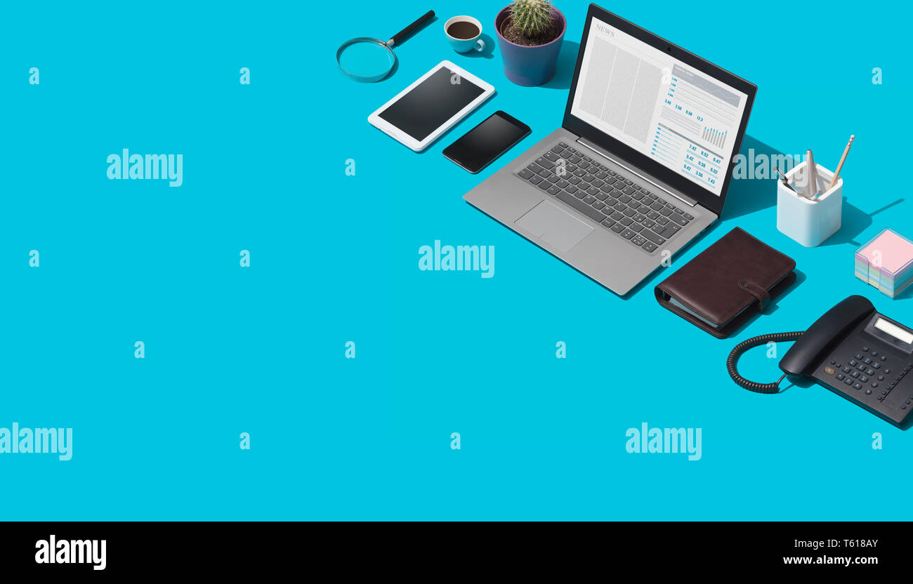 Contemporary corporate business desktop with laptop and isometric