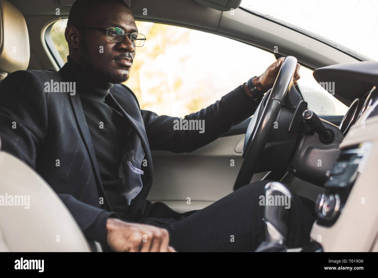 The man presses the buttons in the car. Adjustment of audio volume ...