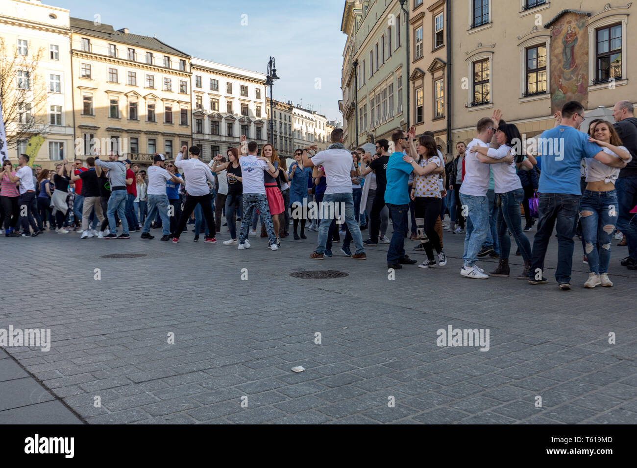 Cracow, Poland - March 30, 2019:  International Flashmob Day of Rueda de Casino. Several hundred persons dance Hispanic rhythms on the Main Square in  Stock Photo