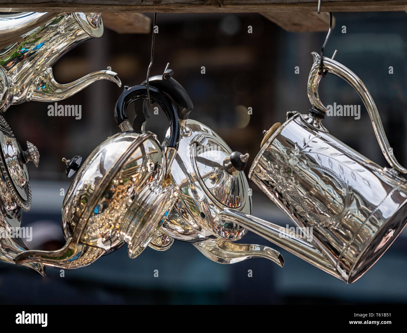 LONDON, UK - JUNE 14, 2018:  Silverware hanging up on a stall at Portobello Road Antiques Market in Notting Hill Stock Photo