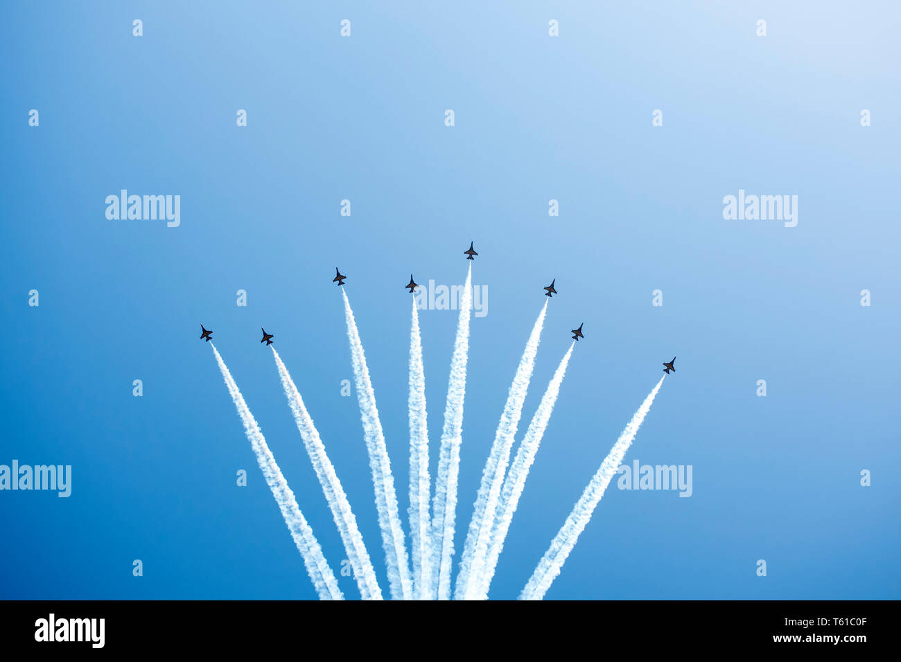 Airplane trails on blue sky with copy space. Stock Photo