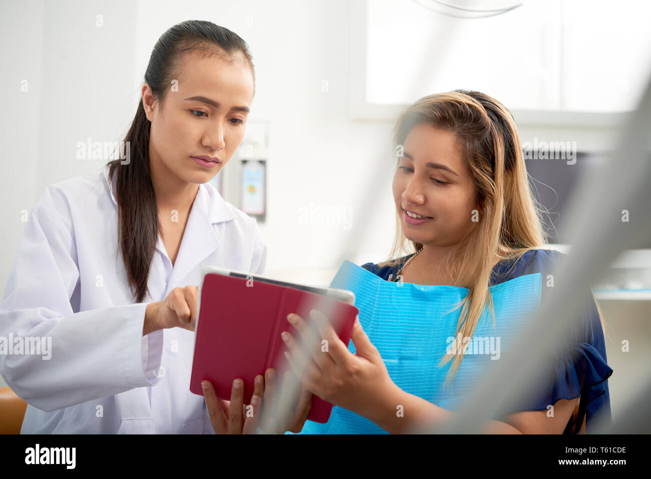 Dentist talking to young patient Stock Photo - Alamy