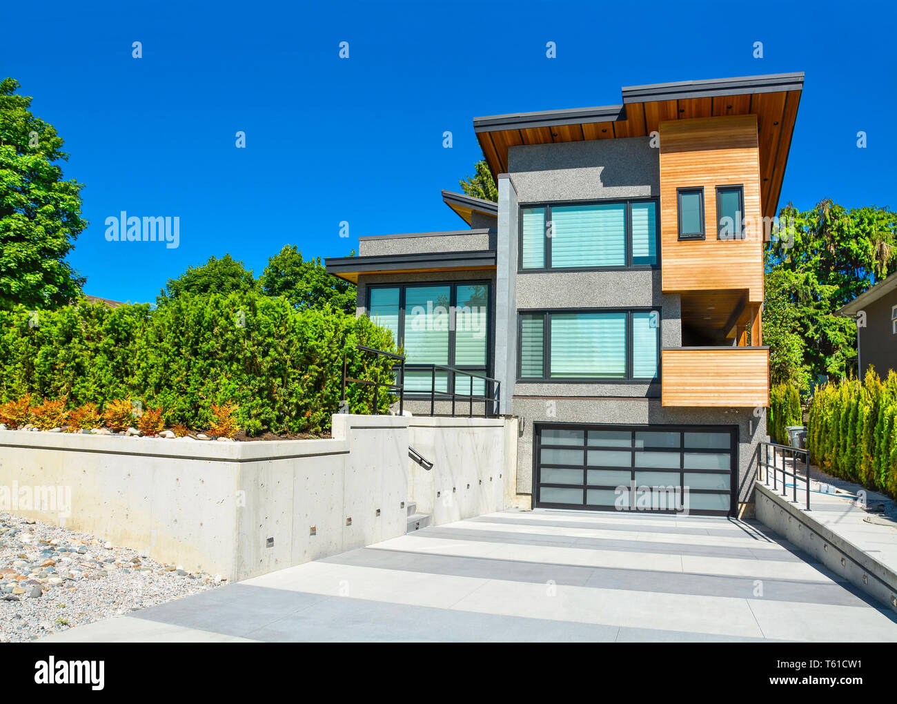 Detached House With Wide Garage For Two Cars And Concrete Driveway