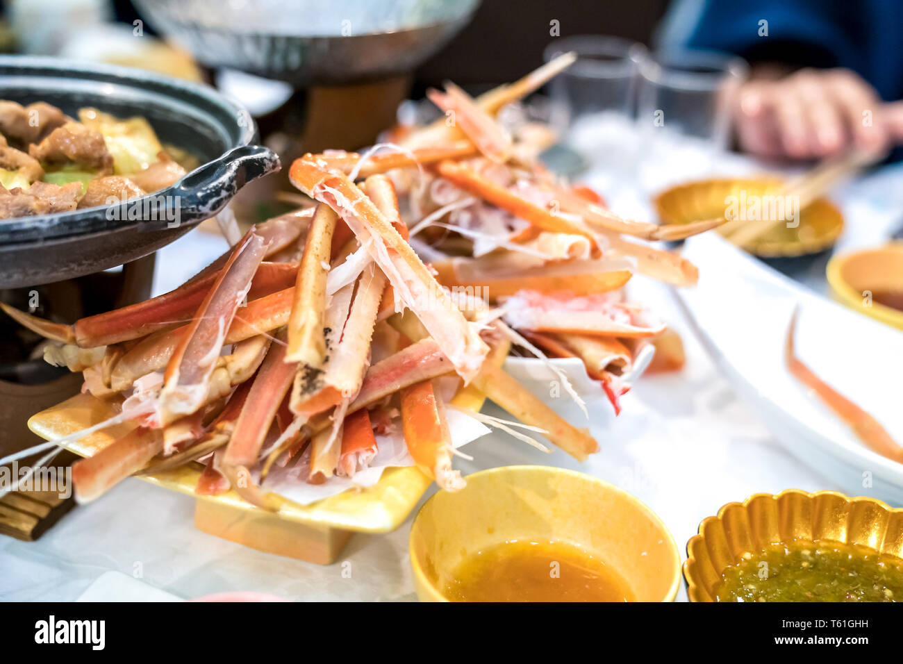 Waste Japanese claw and leg steamed crab on white dish. Look like a graveyard of Crab Stock