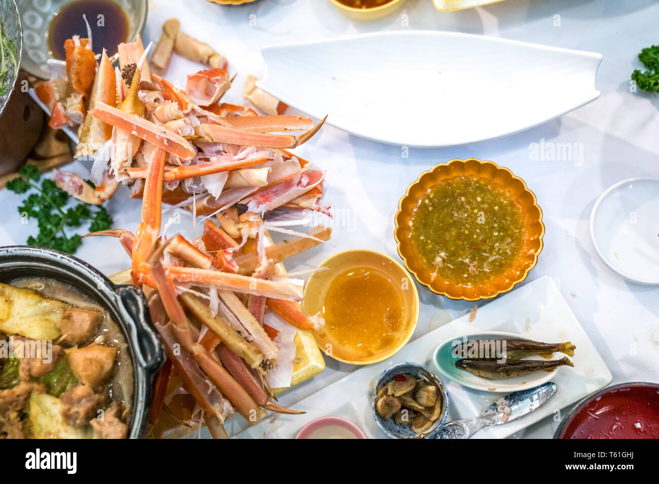 Waste Japanese claw and leg steamed crab on white dish. Look like a graveyard of Crab Stock