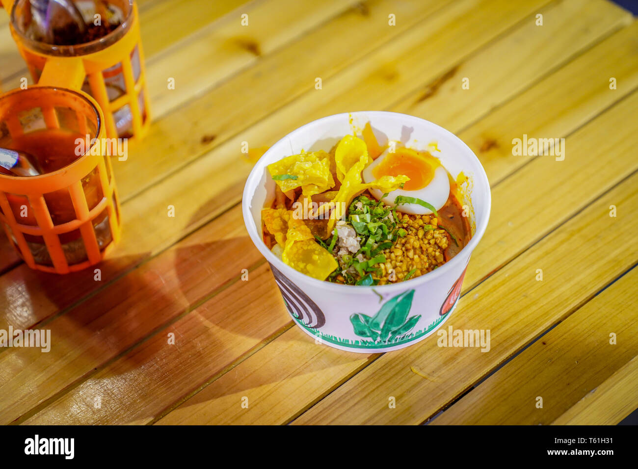 Download Asian Noodle Style In The Paper Bowl With Flavoring Beside On The Wood Table In The Night Stock Photo Alamy