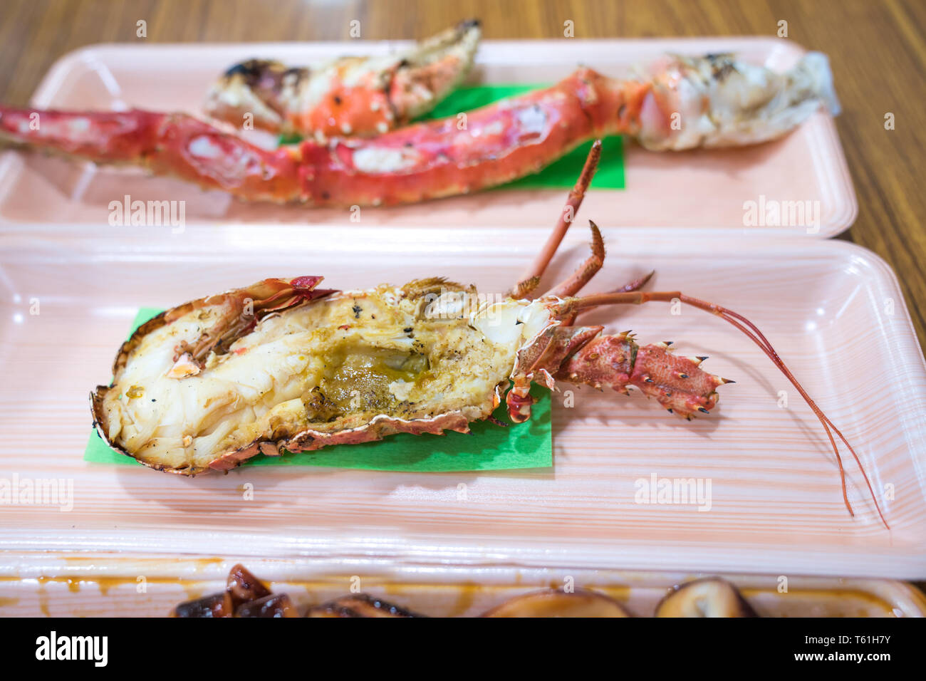 Focus and close up to grilled shrimp in Foam plate on the wood table. Stock Photo