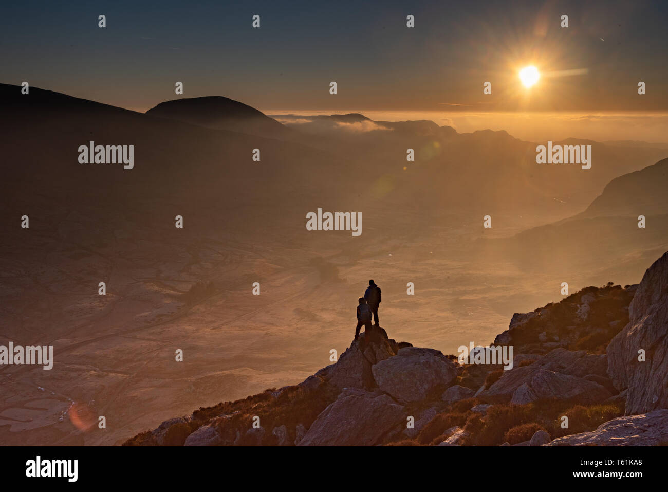 person scrambling climbing welsh mountain try fan in the early morning light Stock Photo