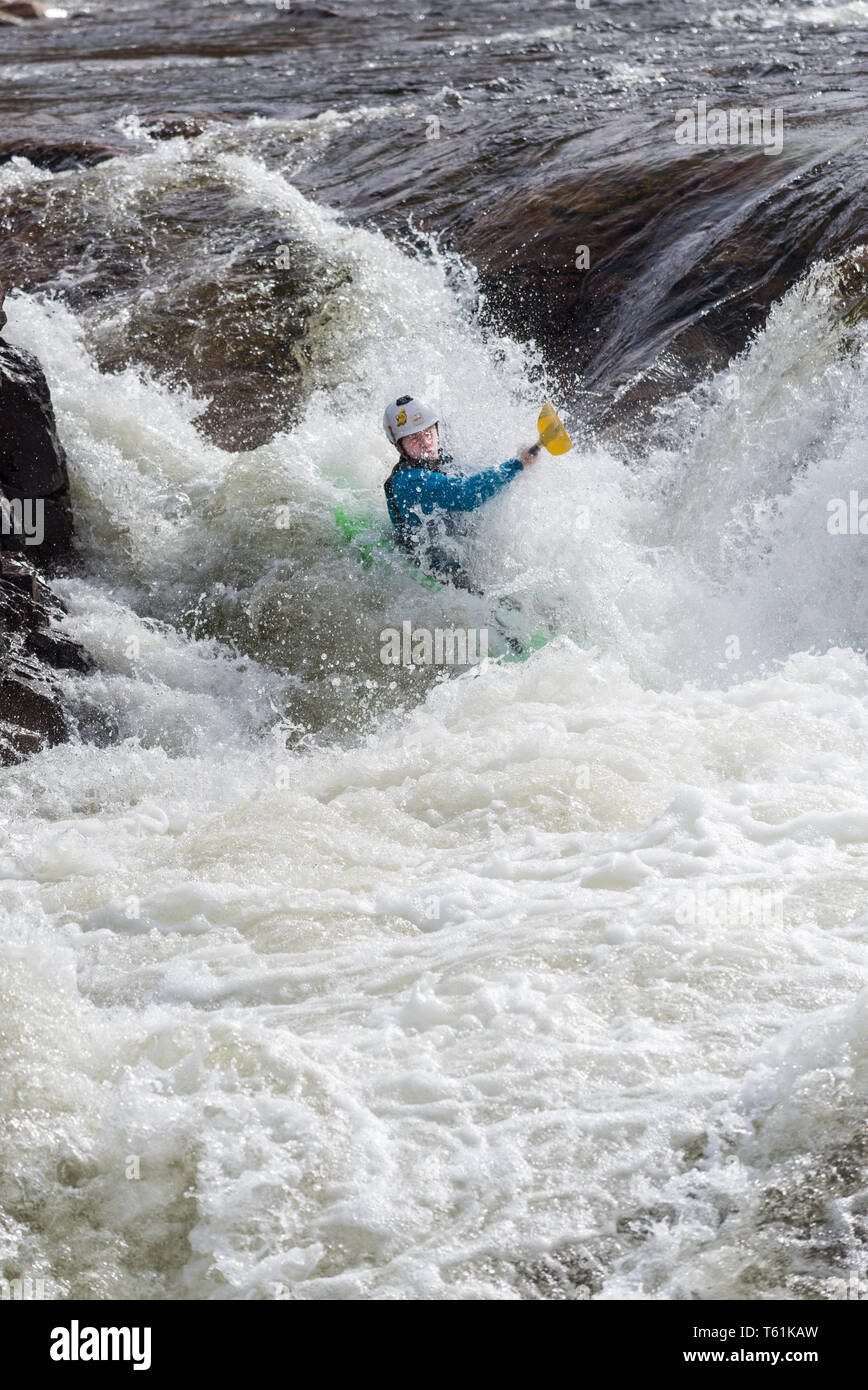 Canoeist on white water river in Glen Etive highlands of Scotland Stock Photo