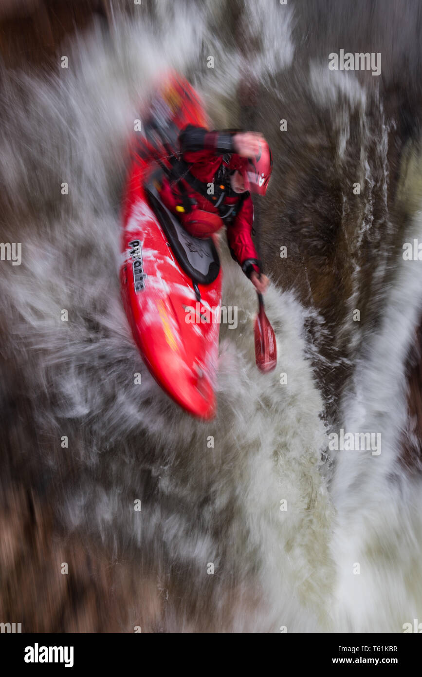 Canoeist on white water river in Glen Etive highlands of Scotland Stock Photo