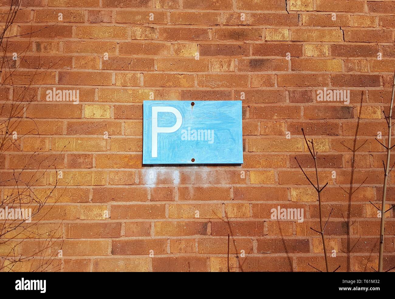 Brick wall background with a P for parking sign Stock Photo - Alamy