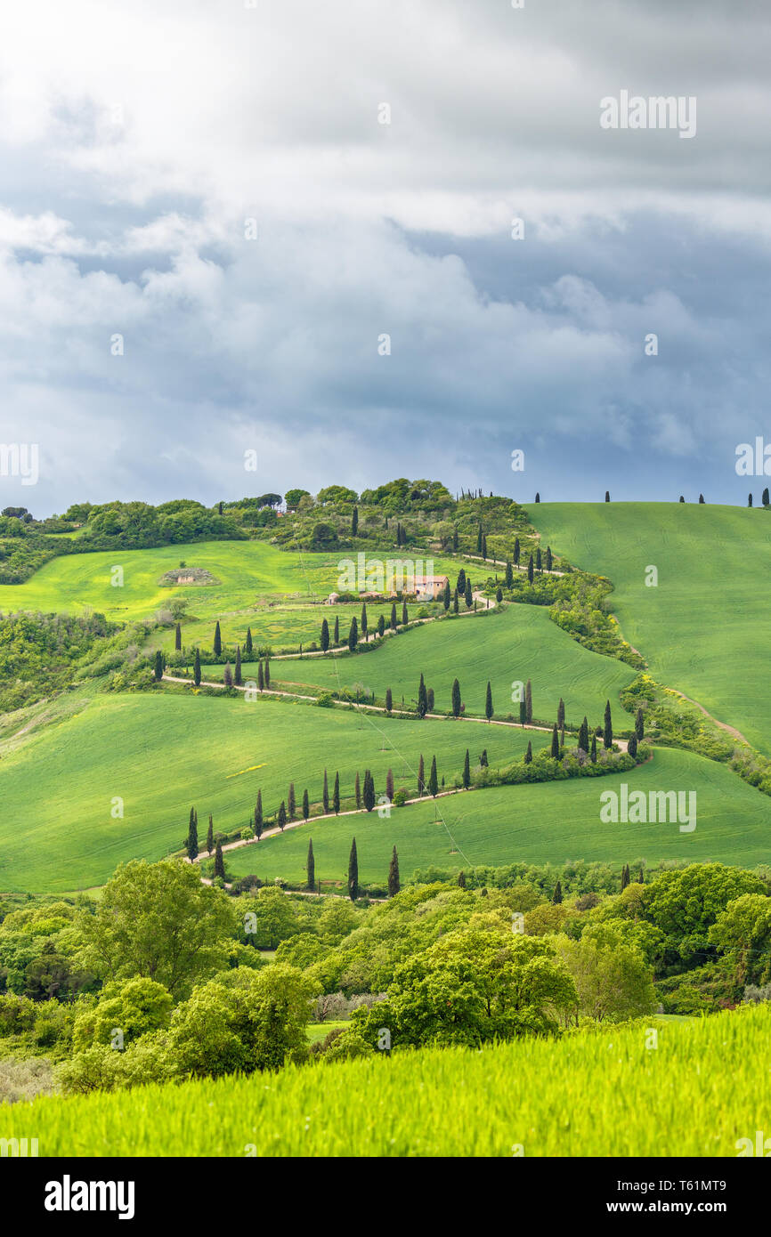 Farmhouse on a hill with a winding road Stock Photo Alamy
