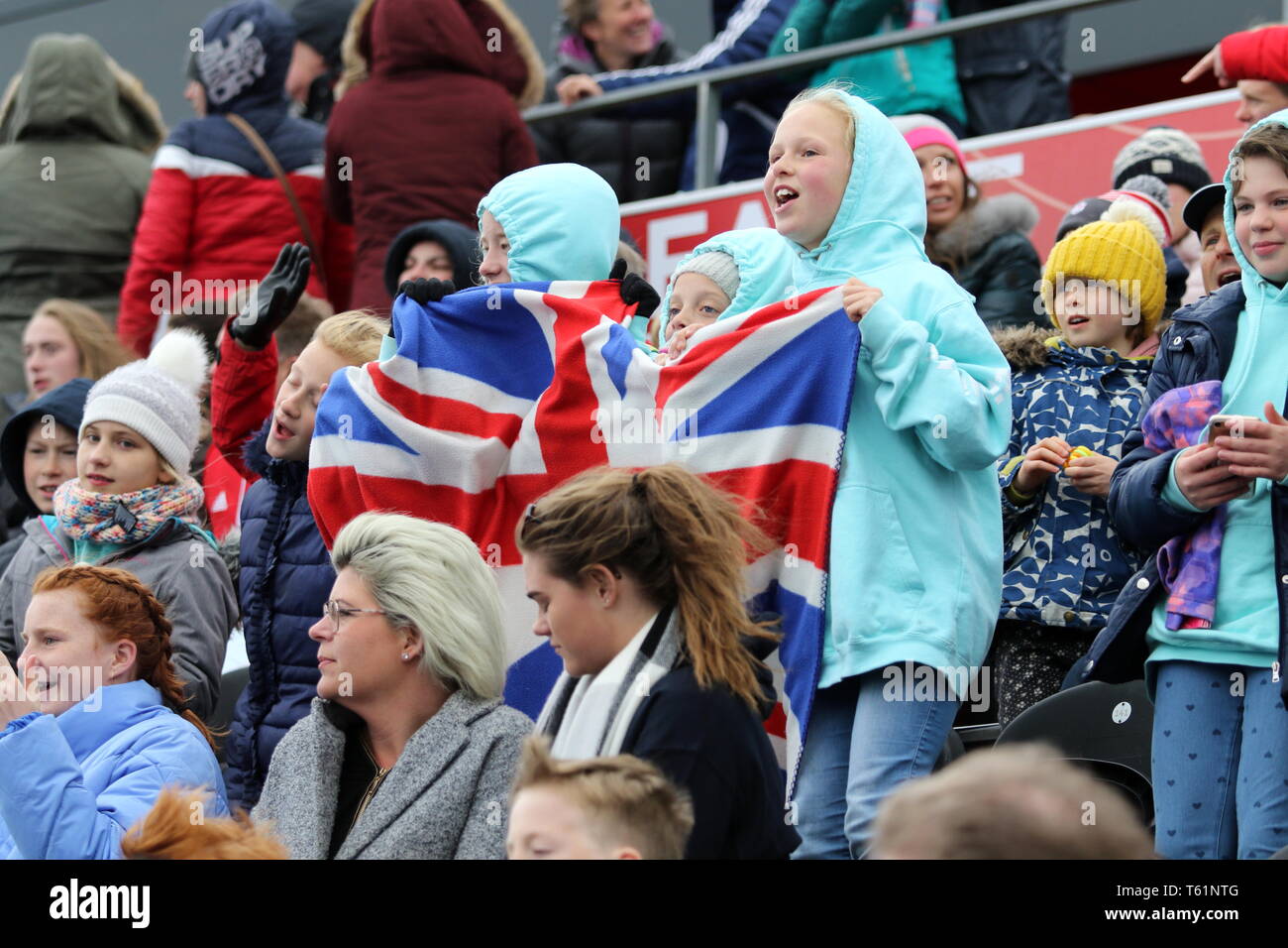 Young fans enjoying the match on a cold afternoon at the 2019 FIH Pro League Great Britain v United States women’s hockey match at the  Olympic Park Stock Photo