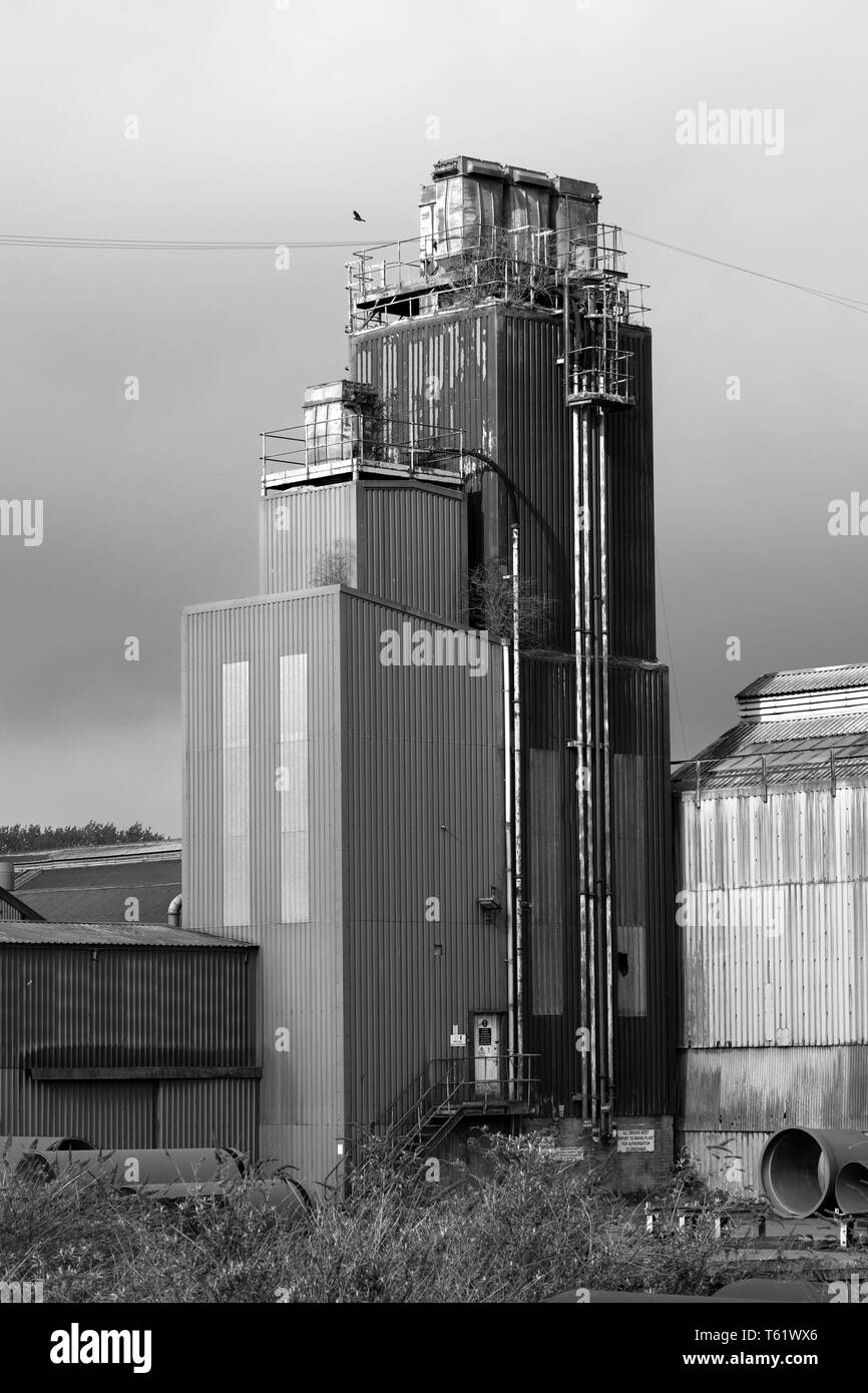 Tall grim corrugated factory tower Stock Photo