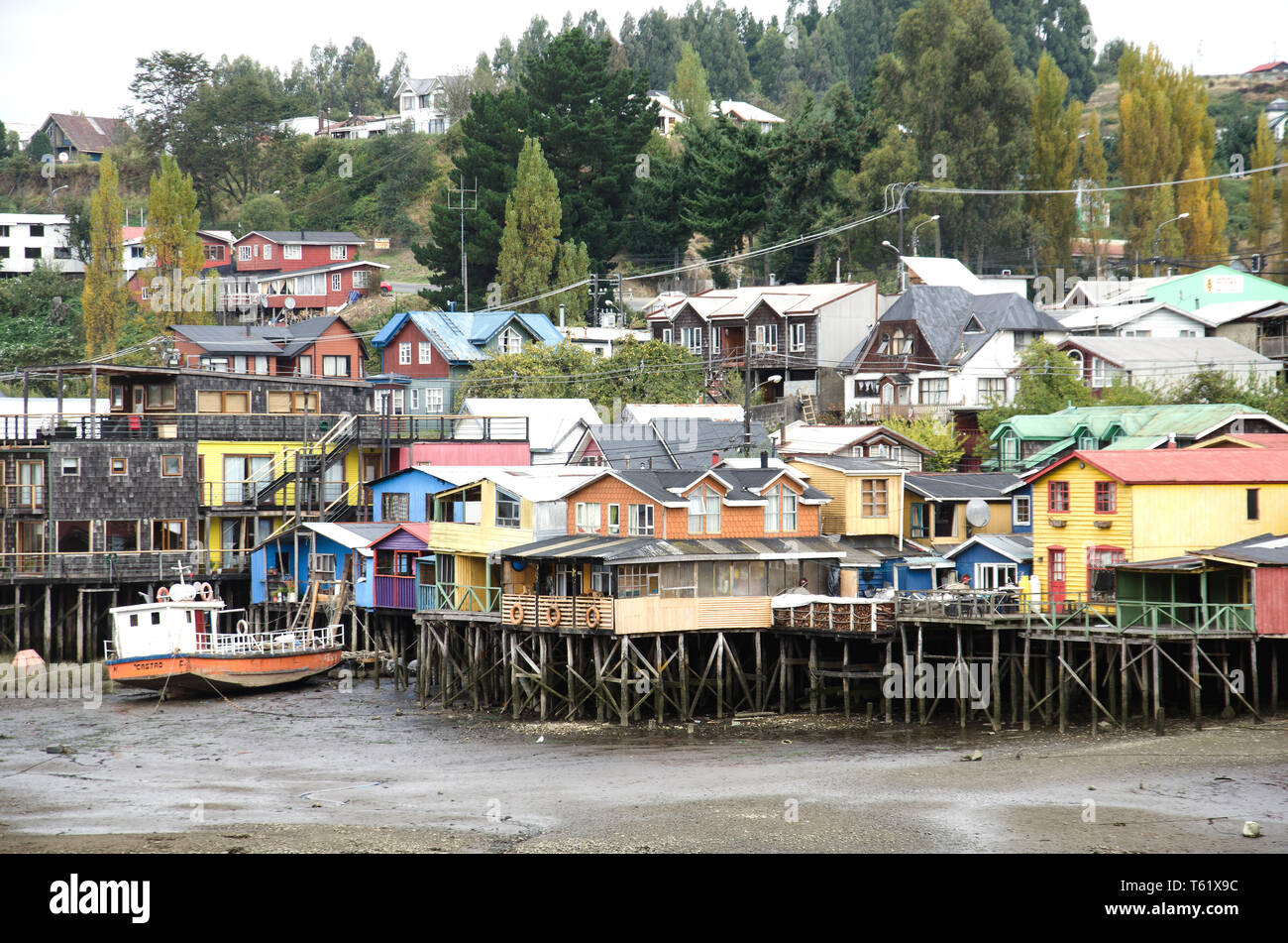 Palafitos, houses on stilts, at the water's edge on the outskirts of Castro, capital town of Chiloé island, Chile Stock Photo