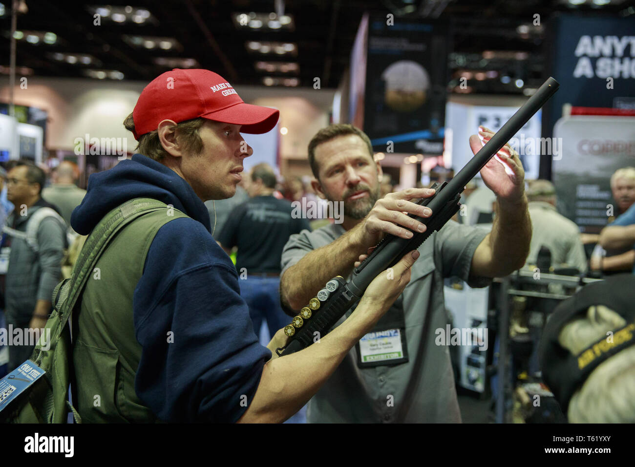 Indianapolis, Indiana, UK. 27th Apr, 2019. An NRA member and Trump supporter wearing a MAGA hat looks at a shotgun during the third day of the National Rifle Association convention. Credit: Jeremy Hogan/SOPA Images/ZUMA Wire/Alamy Live News Stock Photo