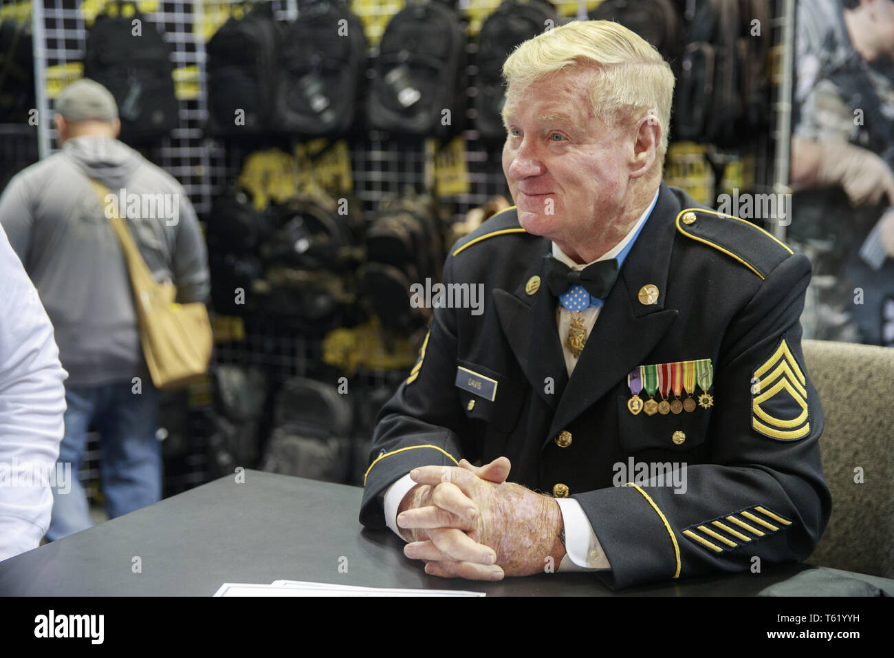 Indianapolis, Indiana, UK. 27th Apr, 2019. Medal of Honor winner and Vietnam Veteran Sammy Davis, who served in the United States Army in Battery C, 2nd Battalion, 4th Artillery, 9th Infantry Division, sits at a table during the third day of the National Rifle Association convention. Davis was an inspiration for the movie character Forrest Gump. Credit: Jeremy Hogan/SOPA Images/ZUMA Wire/Alamy Live News Stock Photo