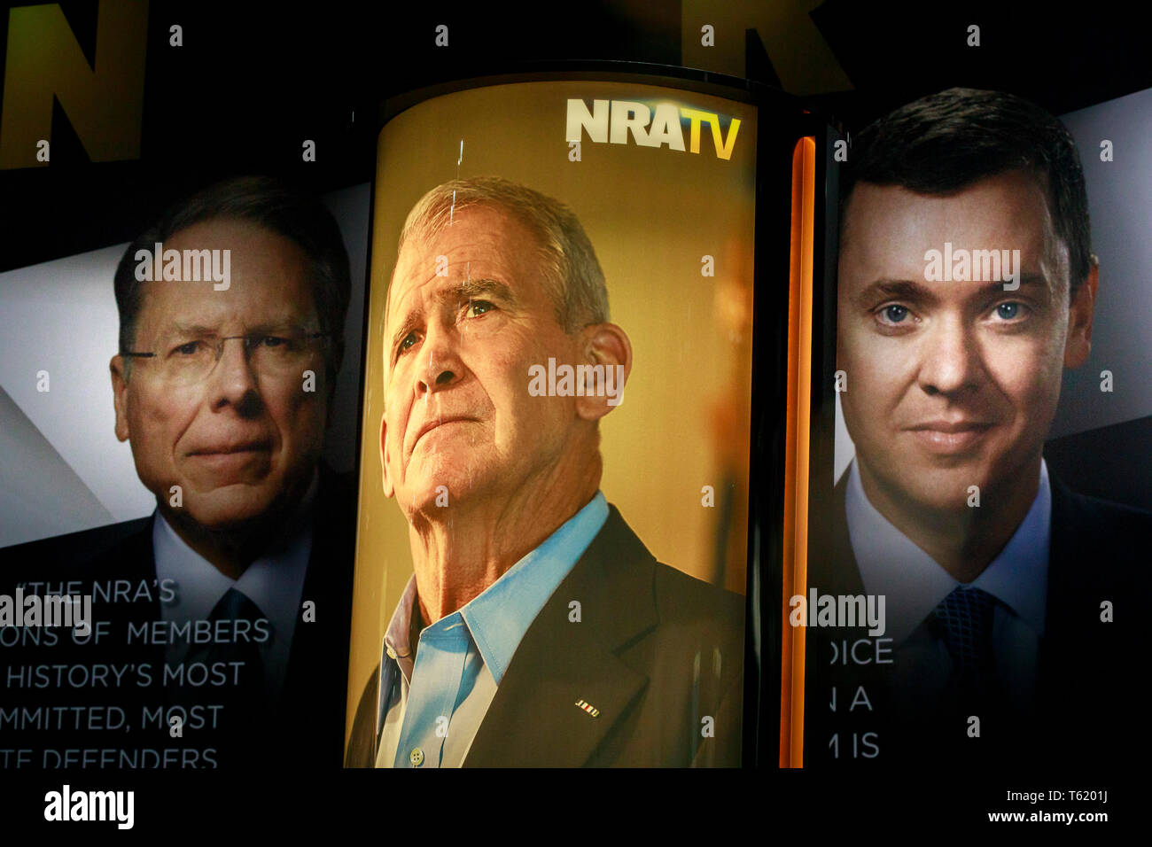 Photos of NRA Chief Executive and Executive Vice President Wayne LaPierre, (L), former president of the NRA Oliver North (M) and chief lobbyist and principal political strategist for the Institute for Legislative Action Chris Cox (R) are on display during the during the third day of the National Rifle Association convention being held nearby. Stock Photo