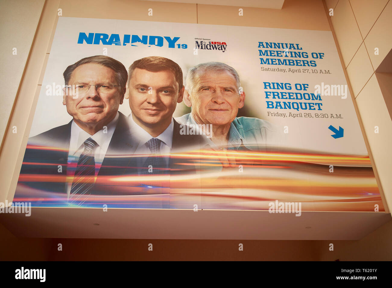A photo of Chief Executive and Executive Vice President Wayne LaPierre, chief lobbyist and principal political strategist for the Institute for Legislative Action Chris Cox and former NRA president Oliver North, is displayed on the Indiana Convention Center during the third day of the National Rifle Association convention. Stock Photo
