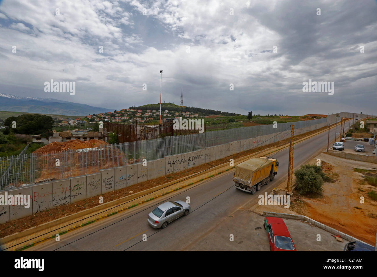 Beirut, Lebanon. 27th Apr, 2019. Vehicles run alongside the separation wall along the border with Israel, in southern Lebanon, April 27, 2019. Israel's construction of a wall along its border with Lebanon is a contentious issue between the two countries. Credit: Bilal Jawich/Xinhua/Alamy Live News Stock Photo