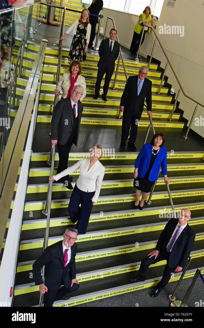Edinburgh, UK. 28, April, 2019. Scotland's Deputy First Minister John Swinney (Bottom R) and Cabinet Secretaries pose for photographs on a staircase proclaiming several of the Scottish Government's claimed achievements at  the Scottish National Party's  Spring Conference in the Edinburgh International Conference Centre, © Ken Jack / Alamy Live News Stock Photo
