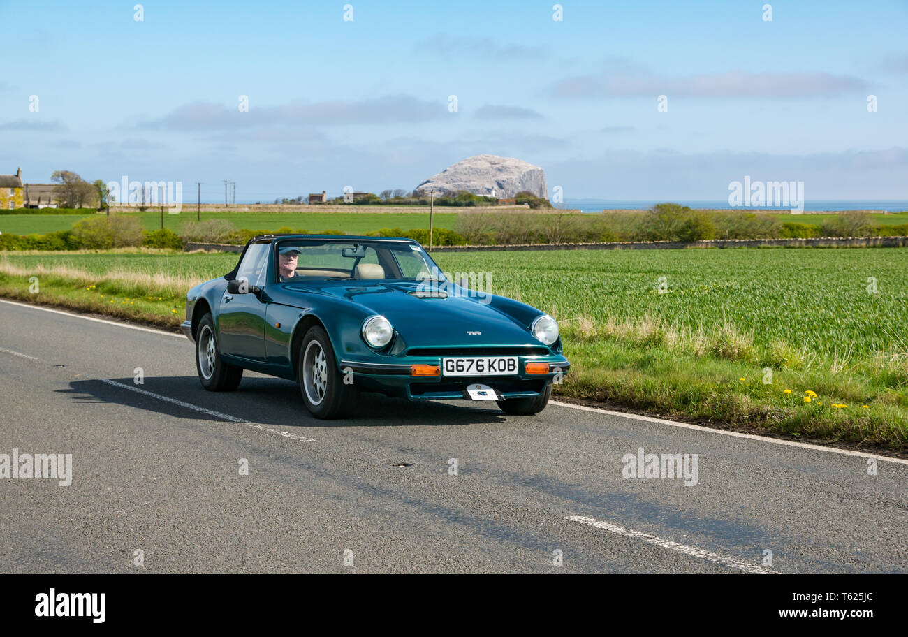 East Lothian, UK. 28 April 2019. Classic Car Tour: North Berwick Rotary Club holds its 3rd rally with 65 classic cars entered. The car rally route is from East Lothian and back through the Scottish Borders, raising money for local charities. A 1990 TVR S2 convertible sports car with  Bass Rock in the background Stock Photo