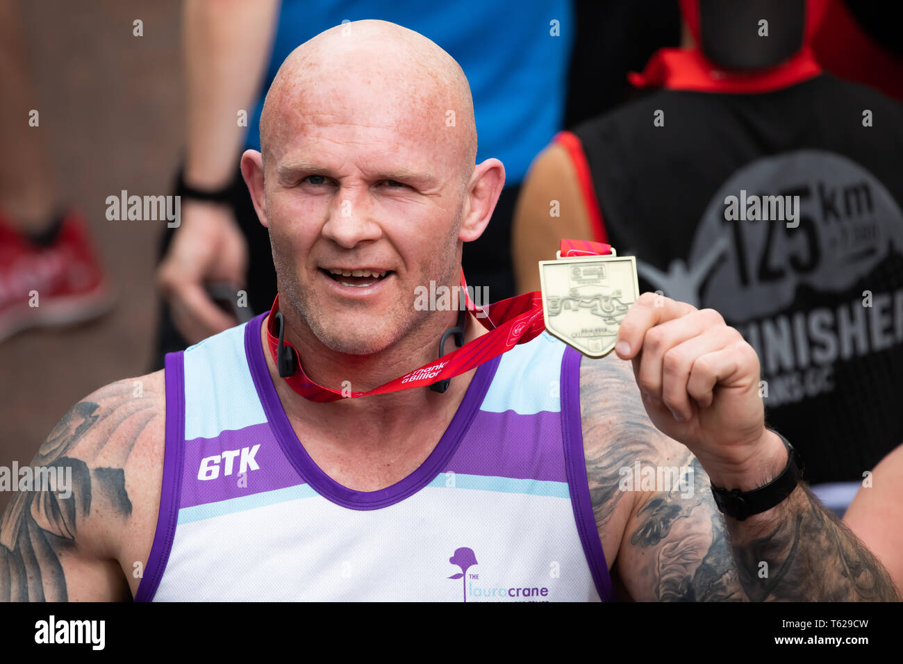 London, UK. 28th April 2019. Keith Senior, English former rugby player with his medal after completing The 39th London Marathon. Credit: Keith Larby/Alamy Live News Stock Photo