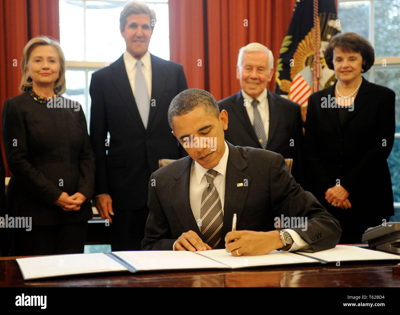 Washington, United States Of America. 02nd Feb, 2011. United States President Barack Obama signs the New START Treaty during a ceremony in the Oval Office of the White House, with, from left, U.S. Secretary of State Hillary Rodham Clinton, U.S. Senator John Kerry (Democrat of Massachusetts), U.S. Senator Richard Lugar (Republican of Indiana), U.S. Senator Dianne Feinstein (Democrat of California). Credit: Leslie E. Kossoff/Pool via CNP | usage worldwide Credit: dpa/Alamy Live News Stock Photo