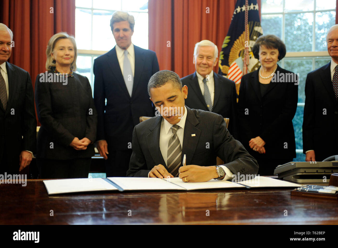 Washington, United States Of America. 02nd Feb, 2011. United States President Barack Obama signs the New START Treaty during a ceremony in the Oval Office of the White House, with, from left, U.S. Secretary of Defense Robert Gates, U.S. Secretary of State Hillary Rodham Clinton, U.S. Senator John Kerry (Democrat of Massachusetts), U.S. Senator Richard Lugar (Republican of Indiana), U.S. Senator Dianne Feinstein (Democrat of California), U.S. Senator Thad Cochran (Republican of Mississippi). Credit: Leslie E. Kossoff/Pool via CNP | usage worldwide Credit: dpa/Alamy Live News Stock Photo