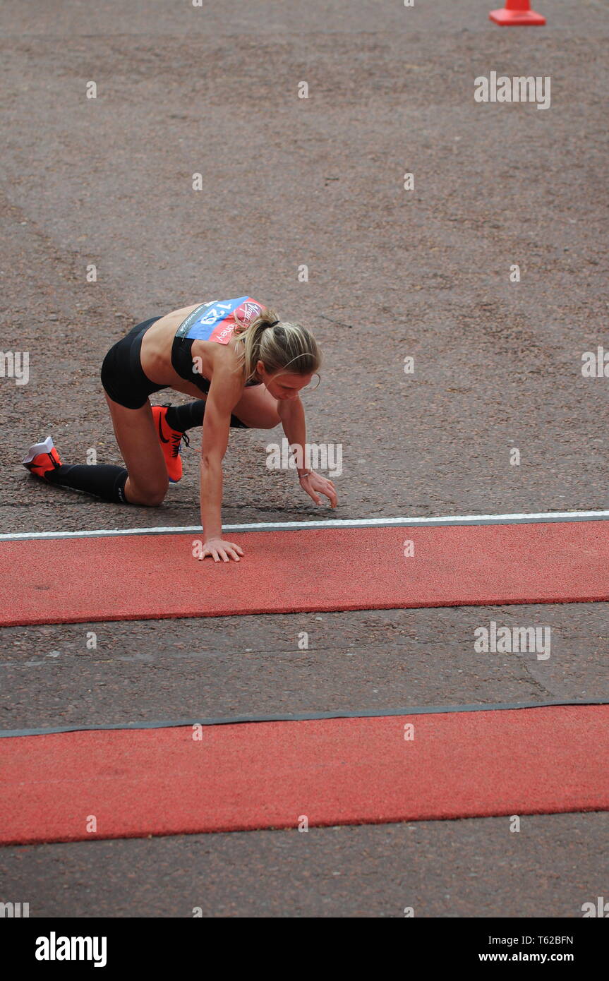 London, UK. 28th Apr, 2019. Hayley Carruthers GB elite women runner collapses at finish line of