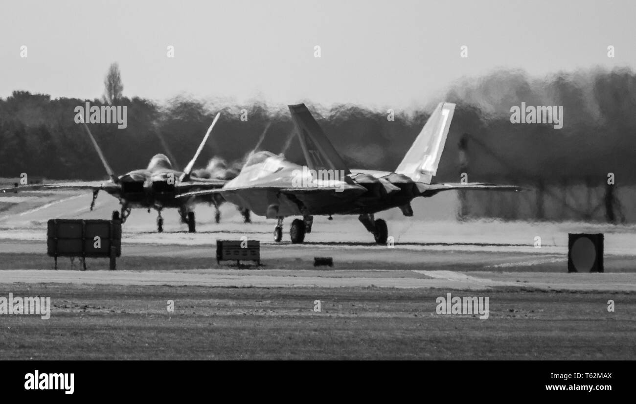 Lockheed Martin F-22A Raptors on taxi seen in black & white. Stock Photo