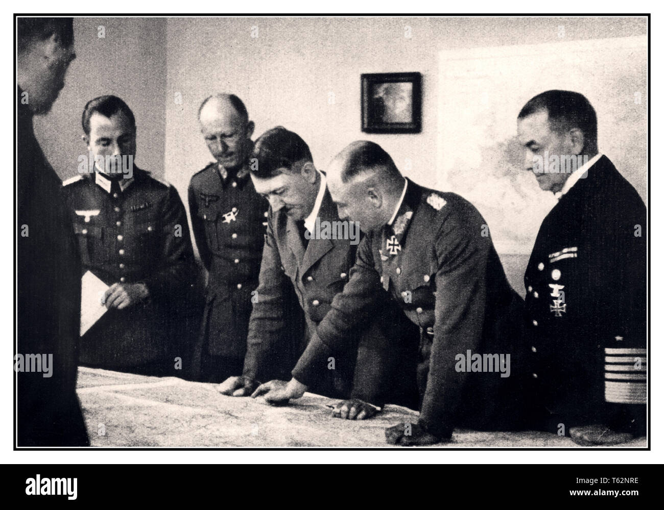 Adolf Hitler with battle maps at Bruly-de-Peche Ardennes WW2 command centre, As pictured to the left of Adolf Hitler is General Alfred Jodl, and on the right Field Marshal Walter von Brauchitsch, commander-in-chief of the army. Next to him Admiral of the Fleet Dr Erich Raeder. 1944 Stock Photo
