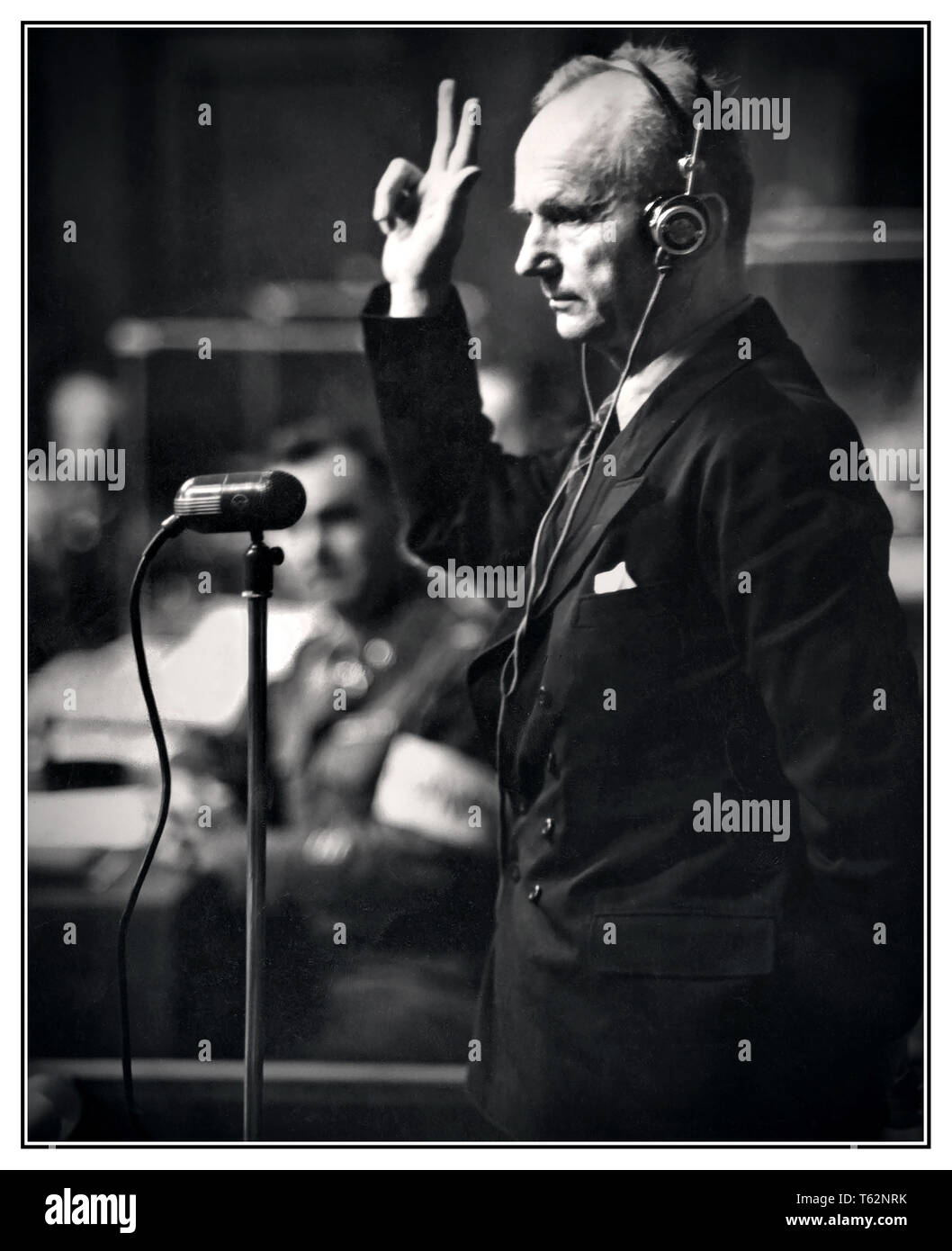 1946 NUREMBERG Karl Donitz Grand Admiral Nazi Germany. Adolf Hitlers successor at the Nuremberg War Trials. Naval Commander, Grand Admiral Karl Donitz raises his hand in oath before taking the witness stand at the International Military Tribunal Palace of Justice Nuremberg Germany 29th August 1946. Stock Photo