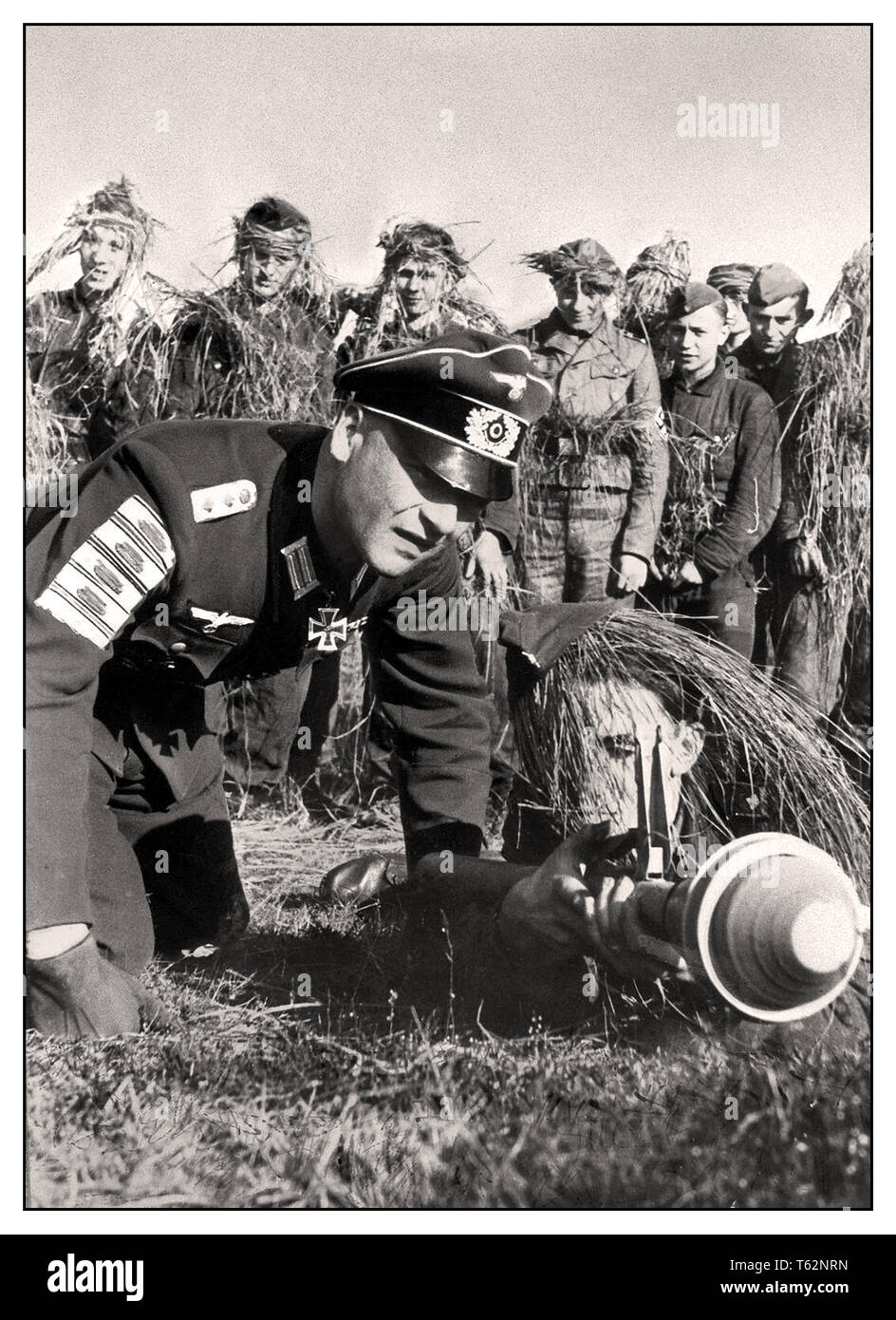HITLERJUGEND Hitler Youth WW2 Germany Propaganda image of a Wehrmacht veteran teaching Hitler Youth boys how to use an anti tank Panzerfaust rocket launcher The badges on his sleeve represent enemy tanks destroyed 1945 Stock Photo