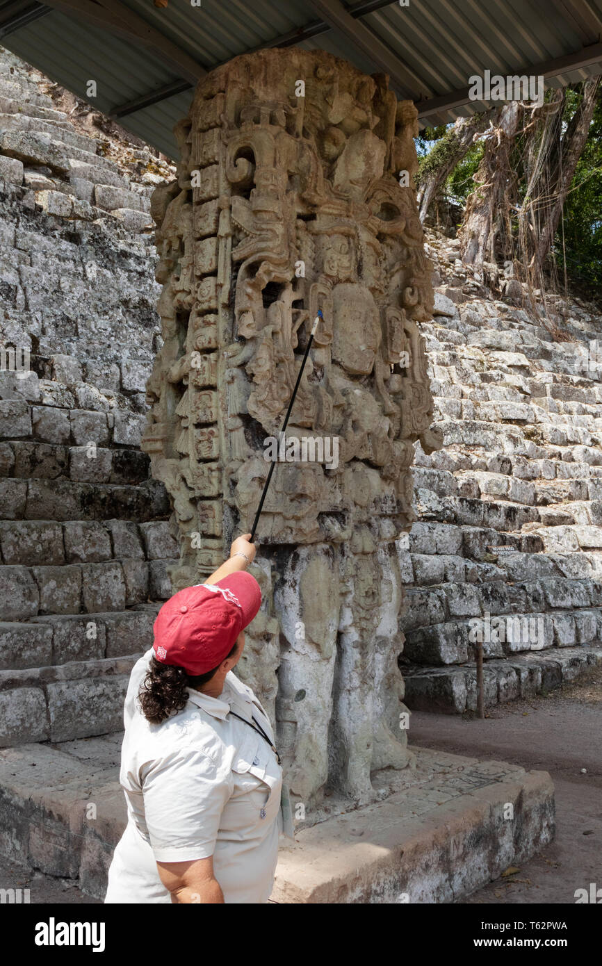 Tour Guide with Stele N, carved standing stone dating from AD 761; Maya ruins - Copan, Honduras Central America. Stock Photo
