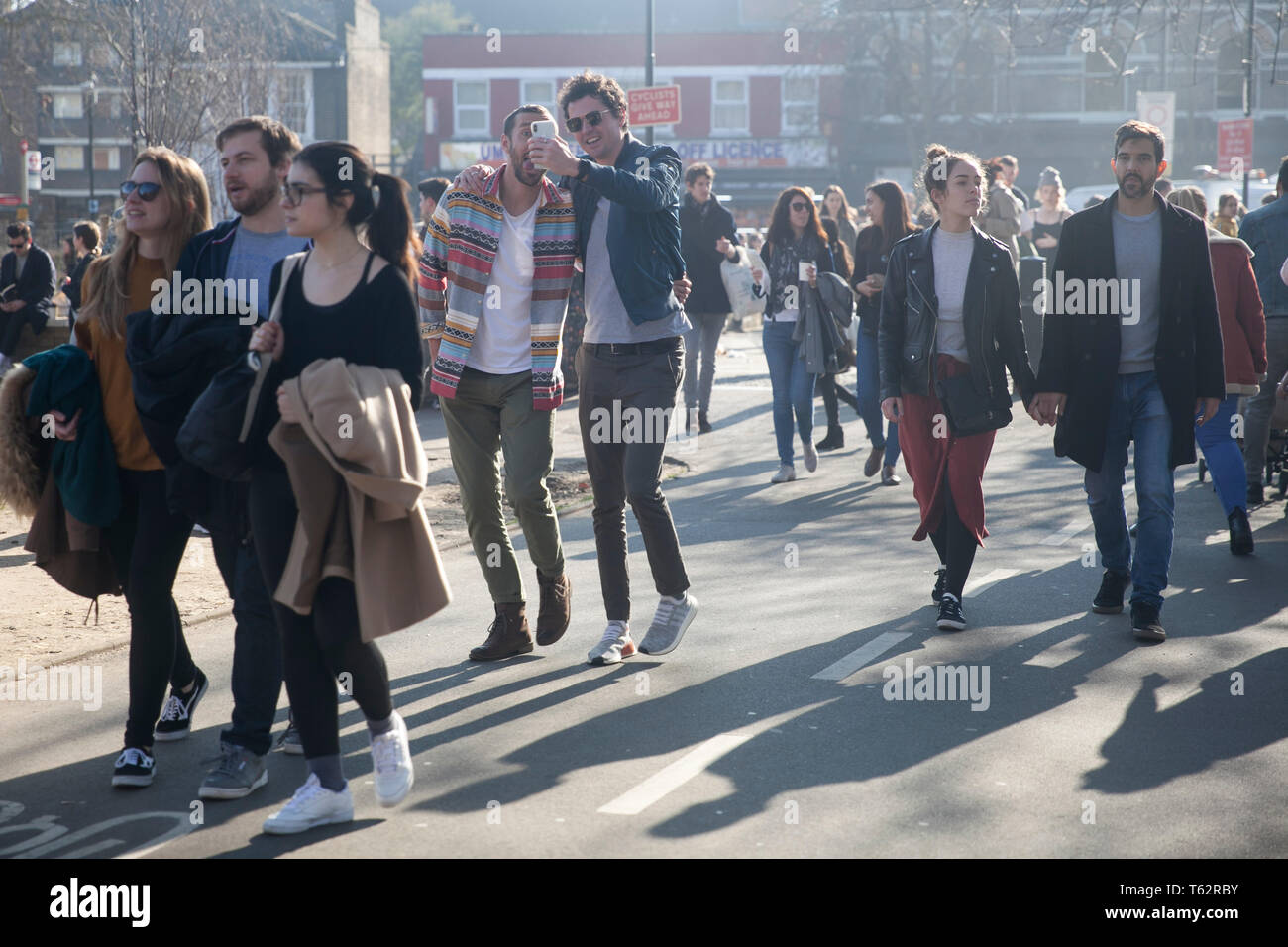 LONDON, UK - APRIL 17, 2019 People at the East London . Men take a selfie using the phone Stock Photo