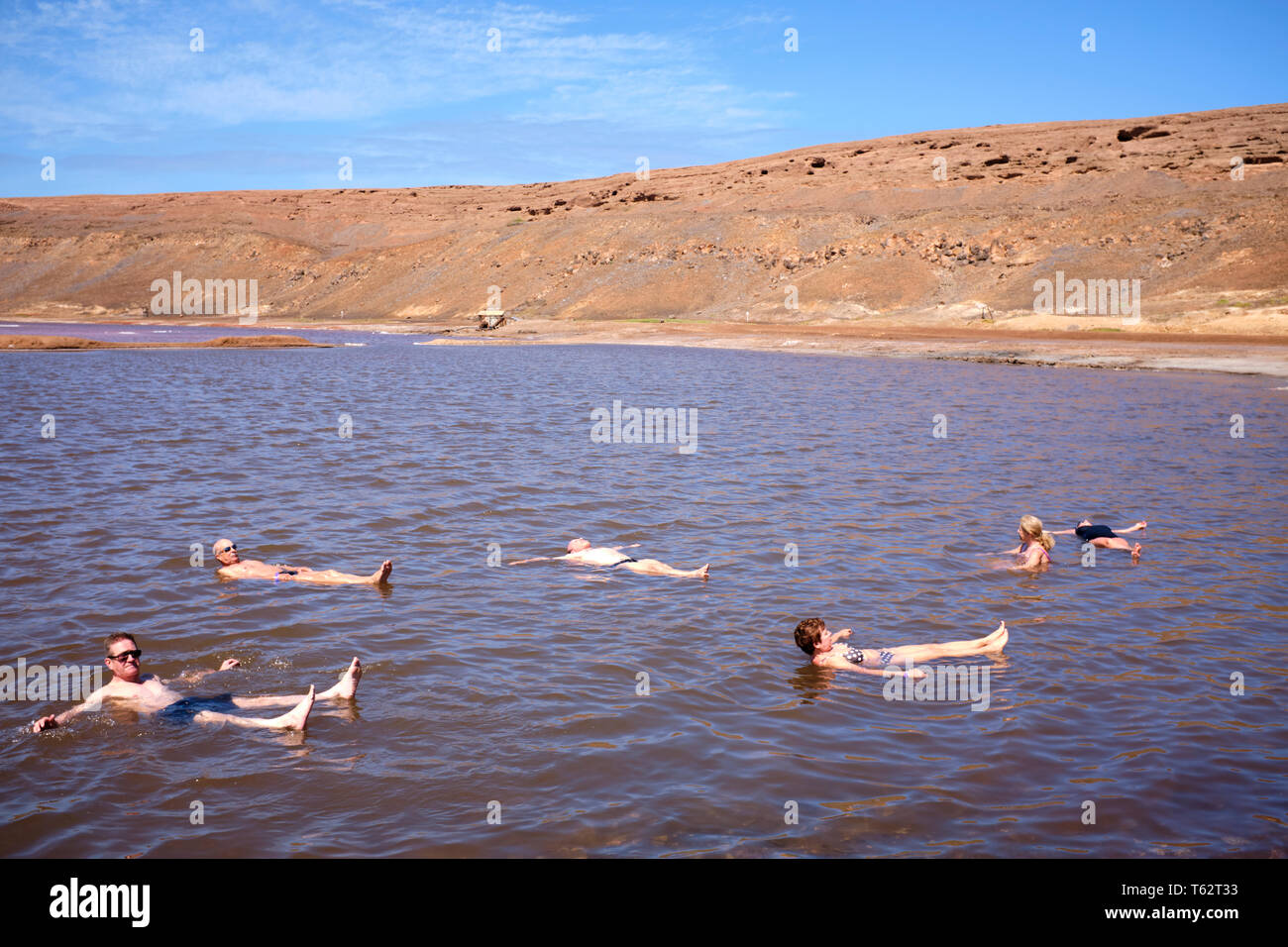 Tourists Floating On A Pool At The Salt Flats, Pedra Lume Salt Crater, Sal Island, Cape Verde, Africa Stock Photo