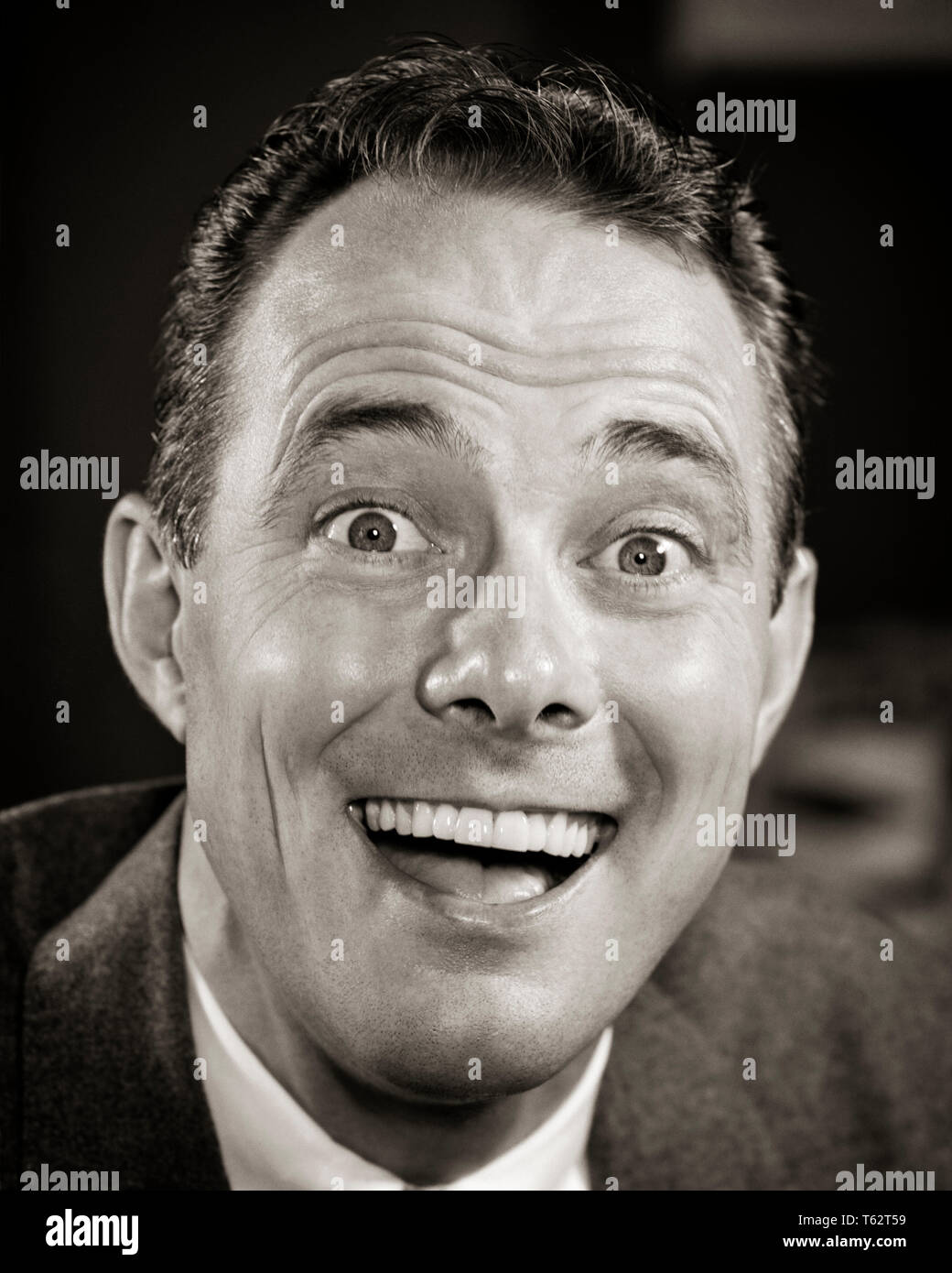 1950s HAPPY LAUGHING MAN FUNNY FACIAL EXPRESSION WITH EYES WIDE OPEN LOOKING AT CAMERA - bx016526 CAM001 HARS MALES CONFIDENCE EXPRESSIONS AMAZED B&W WIDE EYE CONTACT SUCCESS TEMPTATION WONDER AWE DREAMS HAPPINESS HEAD AND SHOULDERS CHEERFUL DISCOVERY VICTORY EXCITEMENT CAM001 PRIDE SMILES AWED CLOSE-UP EXTREME JOYFUL LAUGHTER WIDE-EYED CONFIDENT EAGER EMOTION EMOTIONAL EMOTIONS MID-ADULT MID-ADULT MAN WOW BLACK AND WHITE CAUCASIAN ETHNICITY OLD FASHIONED Stock Photo