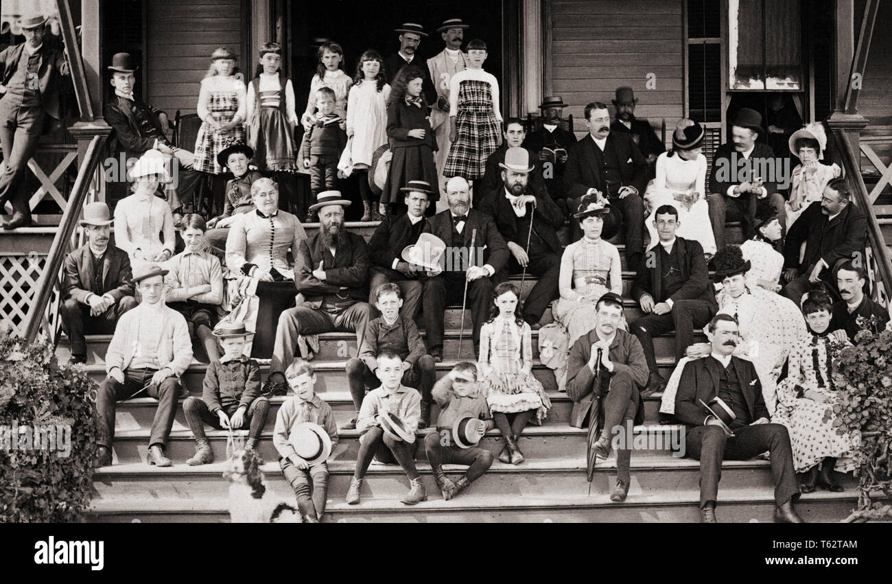 1890s 1900s TURN OF CENTURY GROUP PORTRAIT FAMILY PORCH EXTENDED FAMILY  REUNION IN ASBURY PARK NJ USA - c9941 HAR001 HARS OLDER HUSBAND DOGS DAD  MOM HATS CLOTHING CENTURY NOSTALGIC COMMUNITY SUBURBAN