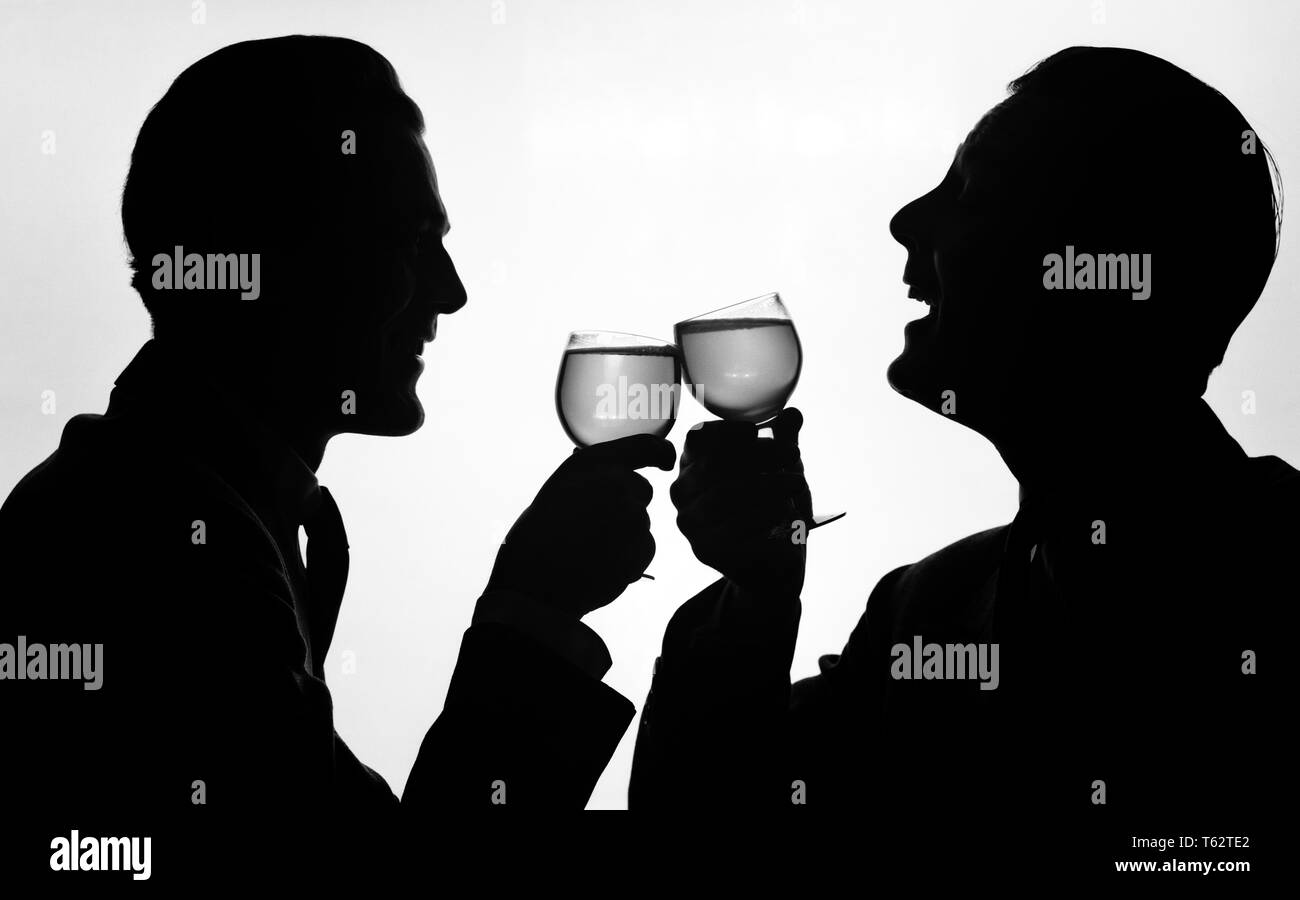 1950s SILHOUETTE TWO HAPPY MEN MAKING TOAST WITH GLASSES OF WINE - f3596 RCH001 HARS EXPRESSIONS B&W GOALS SUCCESS HAPPINESS HEAD AND SHOULDERS CHEERFUL BEVERAGE TOAST VICTORY SILHOUETTED EXCITEMENT FLUID PRIDE SMILES CHEERS JOYFUL NOURISHMENT STYLISH ANONYMOUS MID-ADULT MID-ADULT MAN RELAXATION TOGETHERNESS YOUNG ADULT MAN ALCOHOLIC BEVERAGE BLACK AND WHITE OLD FASHIONED Stock Photo