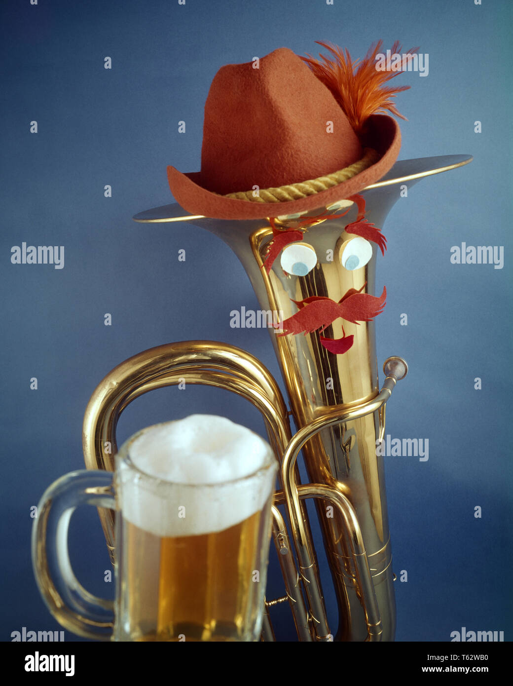 1970s HUMOROUS OKTOBERFEST STILL LIFE BRASS BARITONE HORN WITH BUG-EYED FACE MUSTACHE WEARING BAVARIAN HAT AND GLASS OF BEER   - kf20797 PHT001 HARS CELEBRATION STUDIO SHOT PERSONS FESTIVAL MALES SYMBOLS BRASS ENTERTAINMENT BIZARRE MUSTACHE BUG-EYED HUMOROUS HAPPINESS WEIRD HEAD AND SHOULDERS BEVERAGE AND EXCITEMENT RECREATION ZANY UNCONVENTIONAL OF CONCEPT ANTHROPOMORPHISM BAVARIAN CONCEPTUAL STILL LIFE STYLISH WACKY IDIOSYNCRATIC OKTOBERFEST SYMBOLIC AMUSING BARITONE CONCEPTS ECCENTRIC ERRATIC OLD FASHIONED OUTRAGEOUS REPRESENTATION Stock Photo