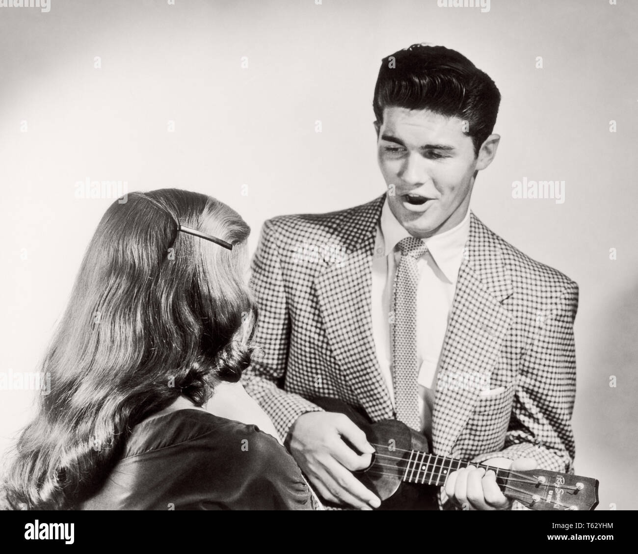 1950s Couple Man Wearing Suit And Tie Singing Playing Ukulele For