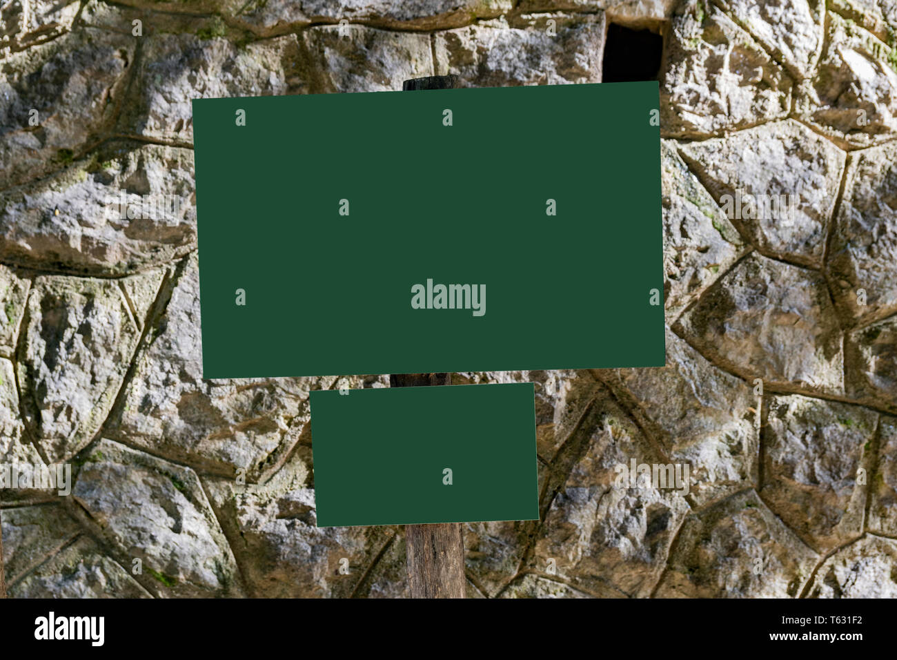 empty billboards in the forest in front of rocky wall Stock Photo - Alamy